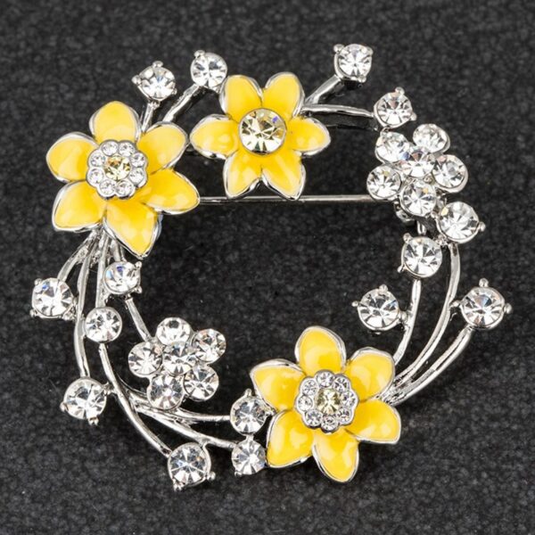 Golden yellow daffodil brooch showing detailed flower petals and tac pin fastening